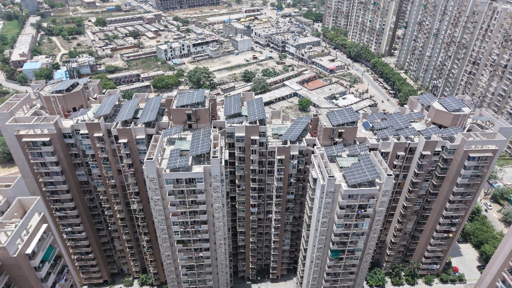 Close aerial view of solar panel arrays on high-rise buildings